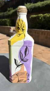 Upcycled boho art style painting welcoming Spring and summer on a bottle